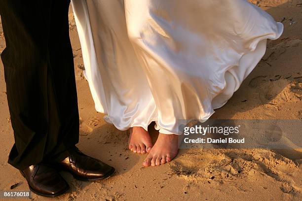 low section of bride and groom  - footprints on beach australia stock-fotos und bilder