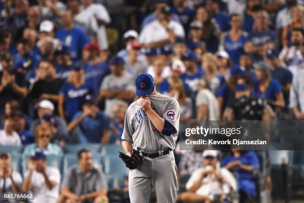 Jon Lester of the Chicago Cubs reacts in the fifth inning against the Los Angeles Dodgers during game two of the National League Championship Series...