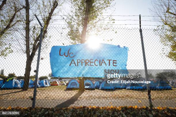 Handmade sign is seen on the fence surrounding a makeshift campground for first responders at the Sonoma County Fairgrounds on Oct. 15, 2017 in Santa...