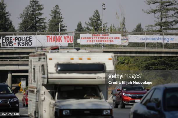 Signs supporting first responders and EMS personnel are seen on a crosswalk over Highway 101 on Oct. 15, 2017 in Santa Rosa, California.