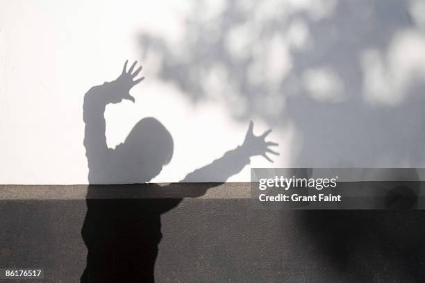 chinese woman's shadow on white wall - tai chi shadow stock pictures, royalty-free photos & images