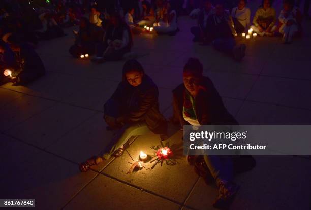 People light candles during a tribute to the victims of Mexico's last earthquake at the esplanade of the Revolution Square in Mexico City, on October...