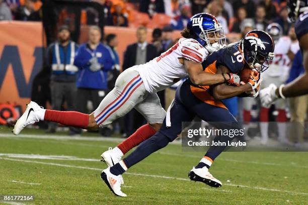 Emmanuel Sanders of the Denver Broncos is tackled by Ross Cockrell of the New York Giants in the third quarter. The Denver Broncos hosted the New...