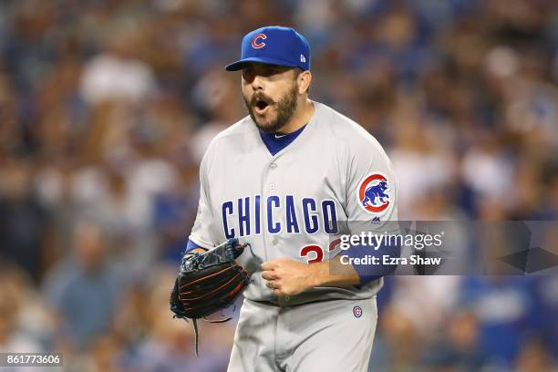 Brian Duensing of the Chicago Cubs reacts after a double play in the eighth inning during Game Two of the National League Championship Series against...