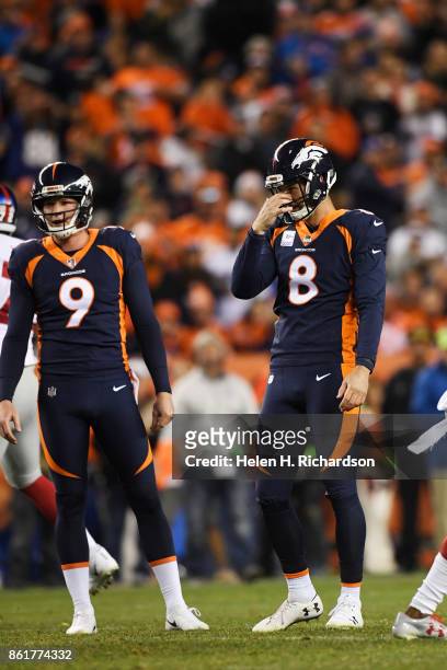 Brandon McManus of the Denver Broncos and Riley Dixon react to McManus's second missed field goal against the New York Giants during the third...