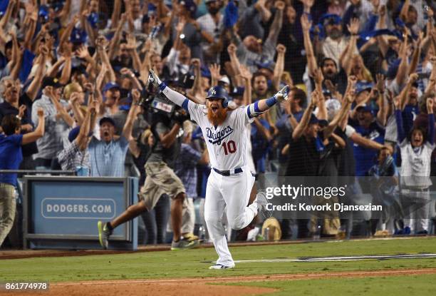 Justin Turner of the Los Angeles Dodgers celebrates after hitting a three-run walk-off home run in the ninth inning to defeat the Chicago Cubs 4-1 in...