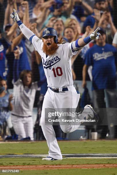 Justin Turner of the Los Angeles Dodgers celebrates after hitting a three-run walk-off home run in the ninth inning to defeat the Chicago Cubs 4-1 in...