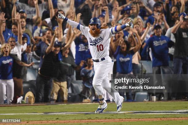 Justin Turner of the Los Angeles Dodgers celebrates after hitting a three-run walk-off home run in the ninth inning to defeat the Chicago Cubs 4-1 in...