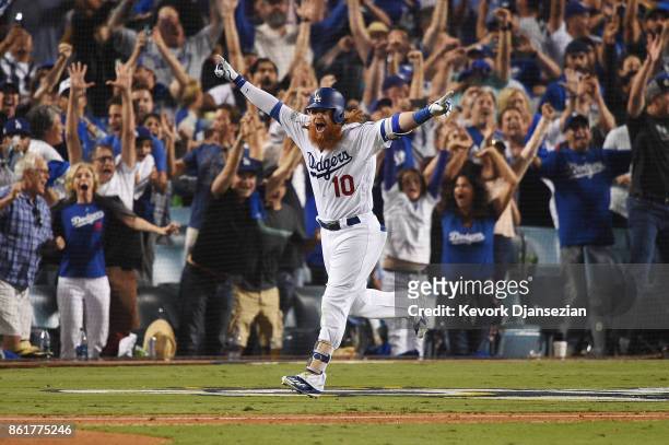 Justin Turner of the Los Angeles Dodgers celebrates after hitting a three-run walk-off home run in the ninth inning to defeat the Chicago Cubs 4-1 in...