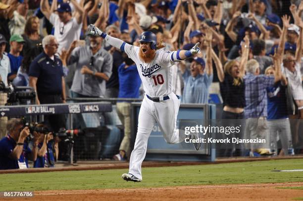 Justin Turner of the Los Angeles Dodgers celebrates after hitting a three-run walk-off home run in the ninth inning to defeat the Chicago Cubs 4-1 in...