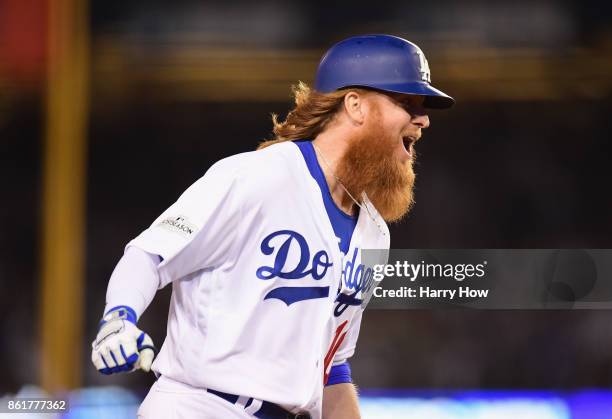 Justin Turner of the Los Angeles Dodgers celebrates as he runs the bases after hitting a three-run walk-off home run in the ninth inning to defeat...