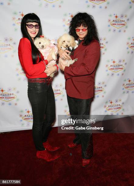 Carmen Shortino and her husband, singer Paul Shortino, pose with rescue dogs from Friends for Life Humane Society at the debut of "Linda Suzanne...