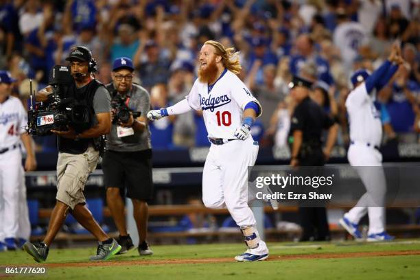 Justin Turner of the Los Angeles Dodgers celebrates after hitting the winning home run in the bottom of the ninth inning making the score 4-1 during...