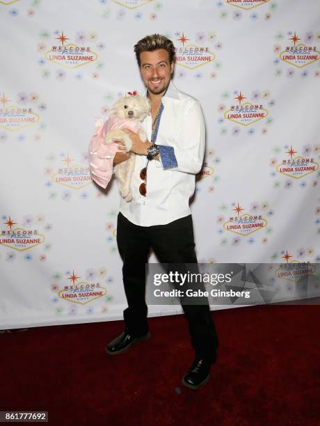 Magician Tommy Wind poses with a rescue dog from Friends for Life Humane Society at the debut of "Linda Suzanne Sings Divas of Pop" at the South...