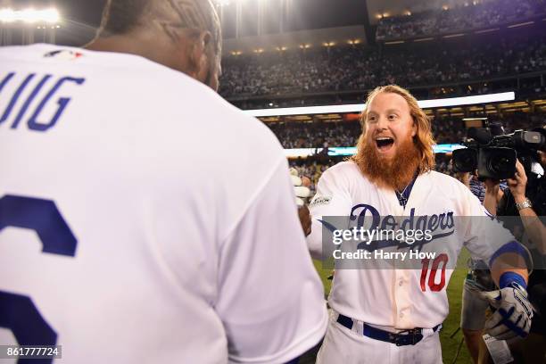 Justin Turner of the Los Angeles Dodgers celebrates with Yasiel Puig after hitting a three-run walk-off home run in the ninth inning to defeat the...