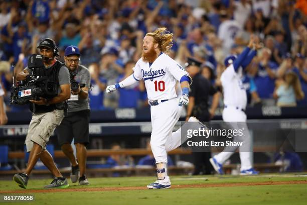 Justin Turner of the Los Angeles Dodgers celebrates after hitting the winning home run in the bottom of the ninth inning making the score 4-1 during...