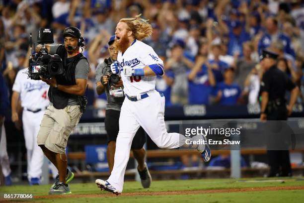 Justin Turner of the Los Angeles Dodgers celebrates after hitting the winning home run in the bottom of the ninth inning making the score 4-1 during...
