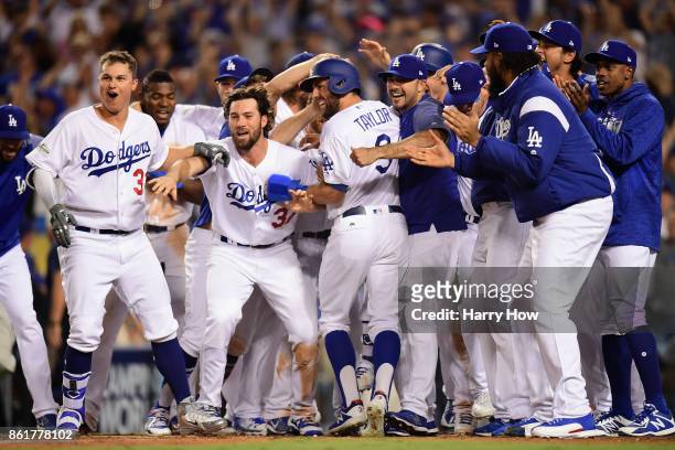 Chris Taylor of the Los Angeles Dodgers celebrates with teammates as he scores a run after Justin Turner · hit a three-run walk-off home run in the...