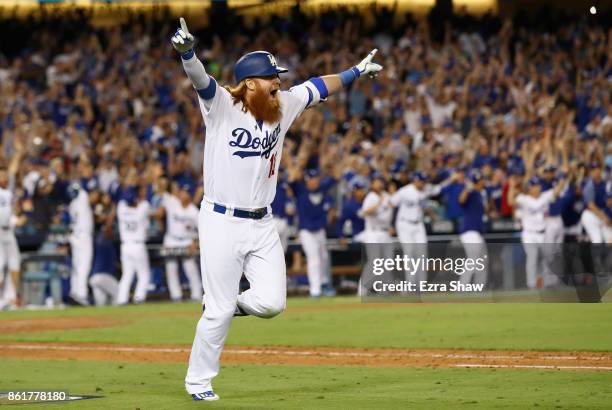 Justin Turner of the Los Angeles Dodgers celebrates after hitting the winning home run in the bottom of the ninth inning making the score 4-1 during...