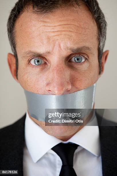 business man with his mouth tabed closed - masking tape stock pictures, royalty-free photos & images