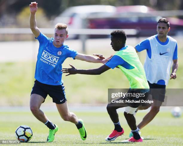 Youth player Nathaniel Atkinson competes for the ball against Bruce Kamau during a Melbourne City A-League training session on October 16, 2017 in...