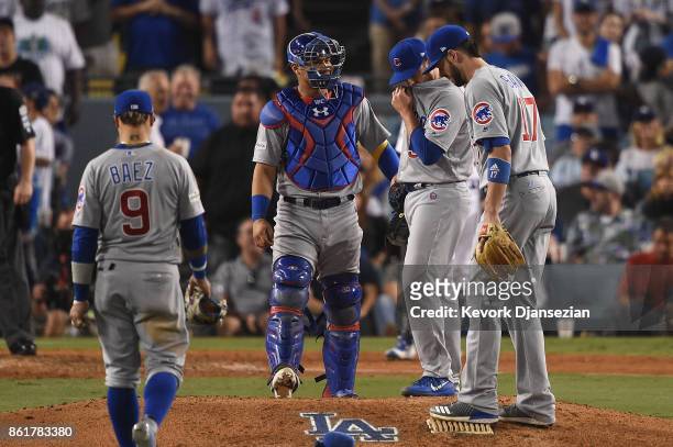 Brian Duensing of the Chicago Cubs meets with teammates on the pitcher's mound in the eighth inning against the Los Angeles Dodgers during game two...