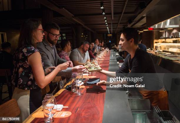 Guests attend a dinner with Masa Takayama as part of the Bank of America Dinner Series presented by The Wall Street Journal during Food Network &...