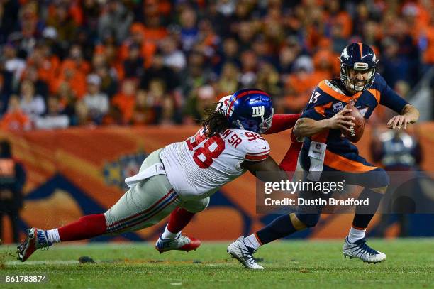 Quarterback Trevor Siemian of the Denver Broncos is sacked by defensive tackle Damon Harrison of the New York Giants in the third quarter of a game...