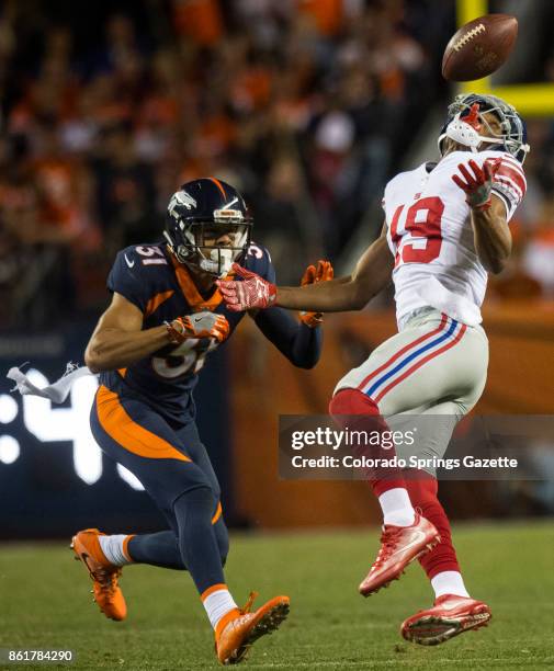 Denver Broncos strong safety Justin Simmons breaks up a pass intended for New York Giants wide receiver Travis Rudolph during the second quarter on...