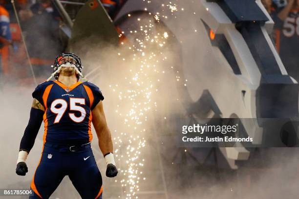 Defensive end Derek Wolfe of the Denver Broncos is introduced to the crowd before a game against the New York Giants at Sports Authority Field at...
