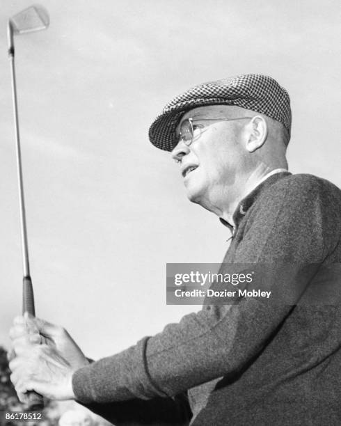 President Dwight Eisenhower watches his ball during a round of golf at Glen Arven Country Club in 1958 in Thomasville, Georgia.