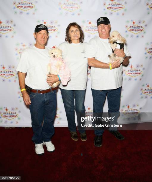 Robert Schrader, Lynette Nelson and Ron Waters pose with rescue dogs that they brought from Friends for Life Humane Society at the debut of "Linda...