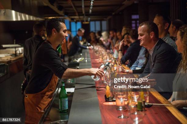 Guests attend a dinner with Masa Takayama as part of the Bank of America Dinner Series presented by The Wall Street Journal during Food Network &...