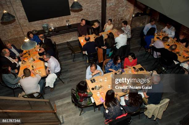 Guests attend a dinner with Masa Takayama as part of the Bank of America Dinner Series presented by The Wall Street Journal during Food Network &...