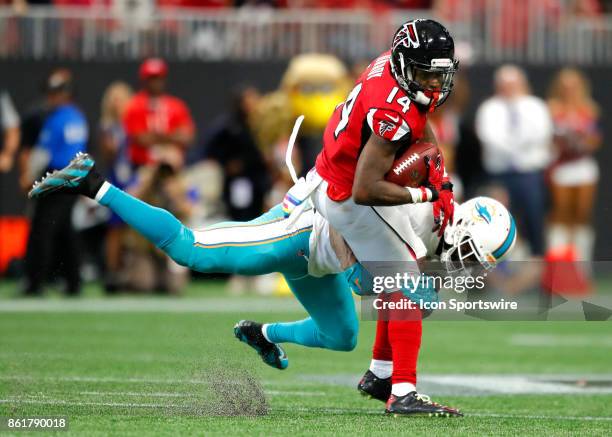 Atlanta Falcons wide receiver Justin Hardy is wrapped up by Miami Dolphins free safety Reshad Jones in the second half of the Miami Dolphins v...