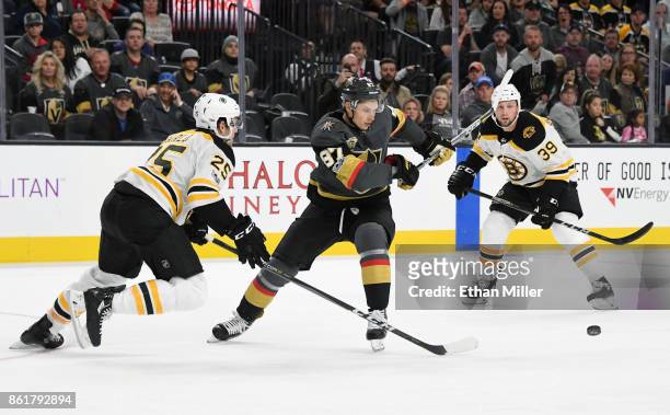Vadim Shipachyov of the Vegas Golden Knights skates with the puck between Brandon Carlo and Matt Beleskey of the Boston Bruins in the second period...