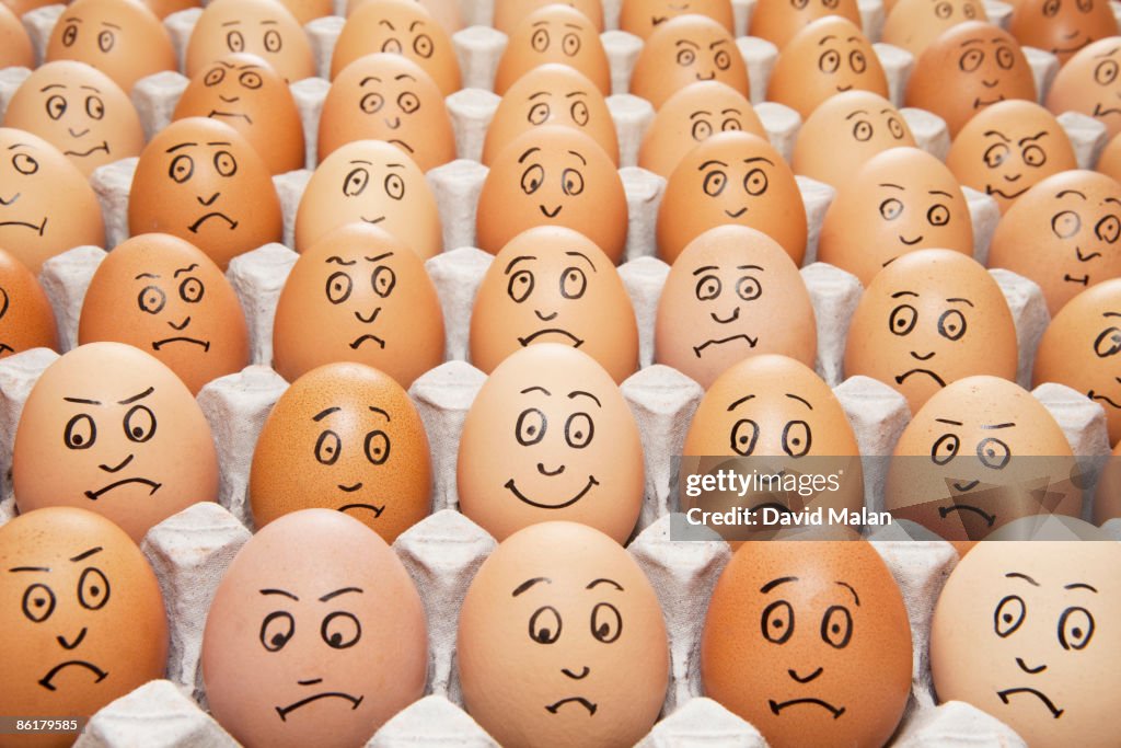 One happy egg amongst sad eggs