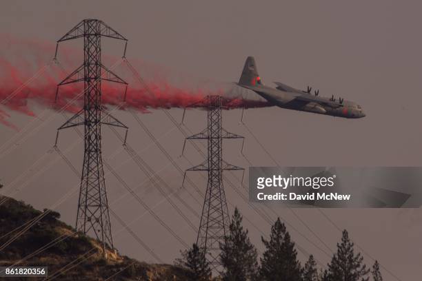 National Guard air tanker drops fire retardant during the Oakmont Fire on October 15, 2017 near Santa Rosa, California. At least 40 people were...