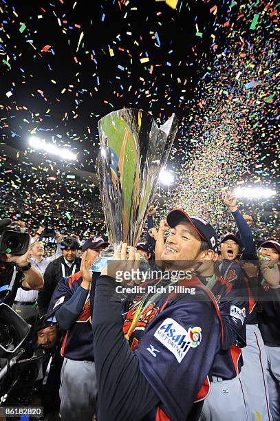 Ichiro Suzuki of Japan holds the trophy after defeating Korea during the World Baseball Classic final game at Dodger Stadium in Los Angeles,...