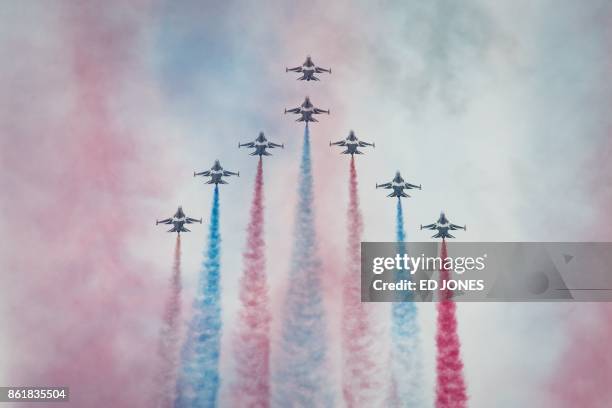 Members of South Korea's 'Black Eagle' aerobatics team perform a display at the Seoul International Aerospace and Defense Exhibition in Seongnam,...