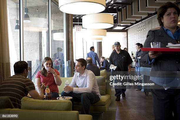 Facebook employees gather for lunch at one of the company's several free restaurants, which employ thirty five cooks and offer themed foods from...