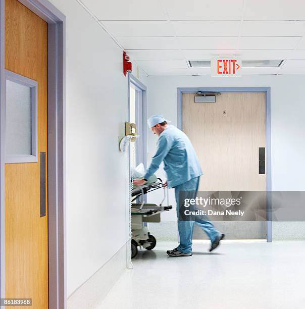 anesthesiologist wheeling patient into surgery - hospital sign stock pictures, royalty-free photos & images