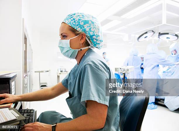 nurse documenting patient  information on computer - protective face mask side stock pictures, royalty-free photos & images