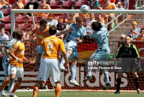 Bobby Boswell of the Houston Dynamo defends a header against Pablo Mastroeni of the Colorado Rapids at Robertson Stadium on April 19, 2009 in...
