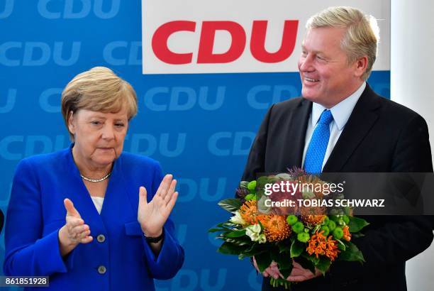 German Chancellor Angela Merkel, leader of the conservative Christian Democratic Union , applauds Bernd Althusmann, her party's top candidate for...