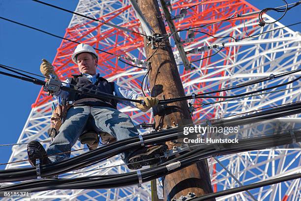 cable lineman repairing transmission line - microwave tower stock pictures, royalty-free photos & images