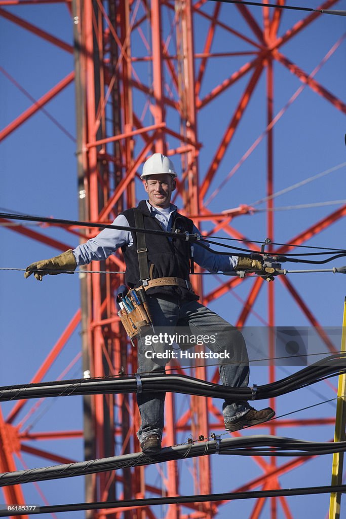 Cable lineman repairing transmission line