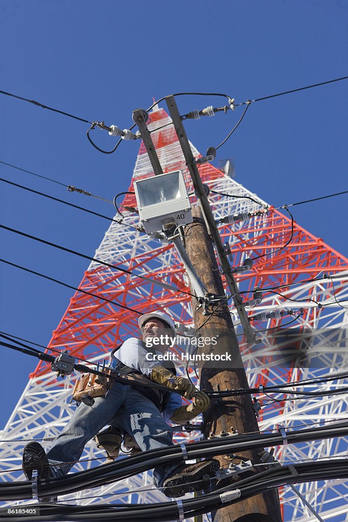 Cable lineman repairing transmission line