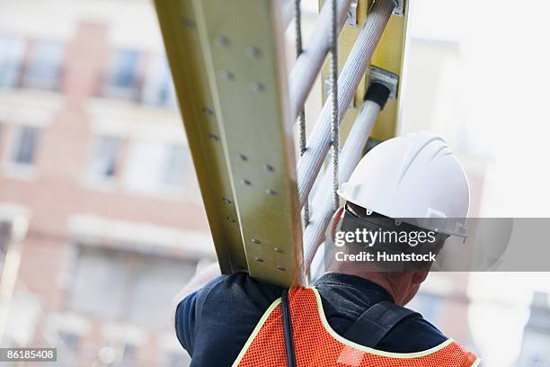 lineman carrying a ladder - cable installer stockfoto's en -beelden