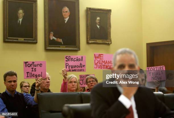 David Swanson of Democrats.com, Mike Marceau of Veterans for Peace, Gael Murphy and Liz Hourican of Code Pink protest as U.S. Attorney General Eric...